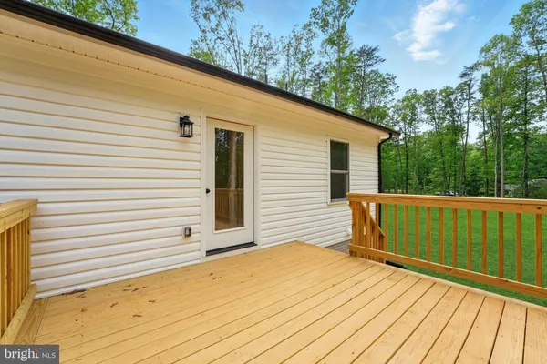 a view of a balcony with wooden floor and fence
