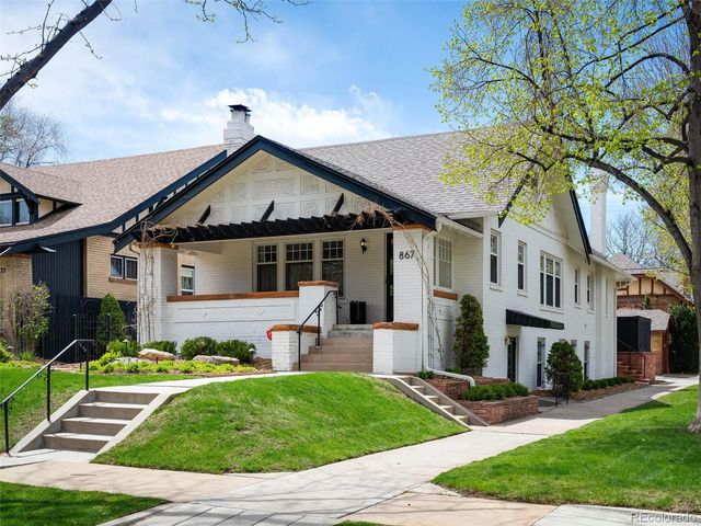a front view of a house with a yard and outdoor seating