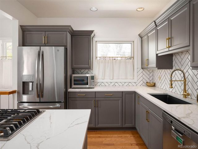 a kitchen with a sink stove and refrigerator