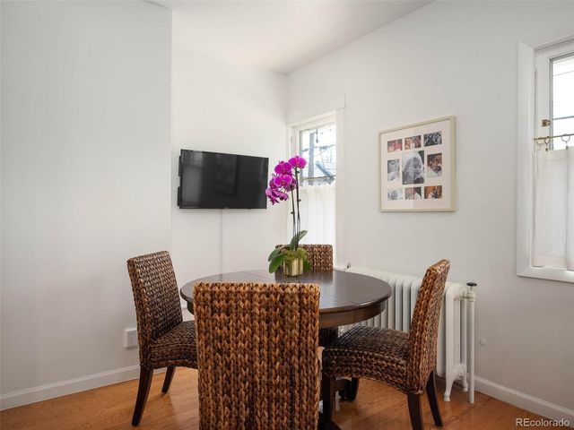 a view of a dining room with furniture and wooden floor