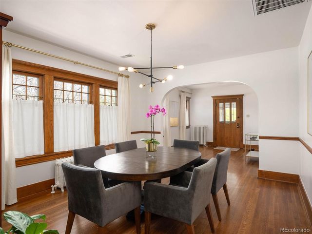a view of a dining room with furniture window and wooden floor