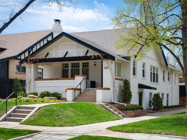 a front view of a house with a yard and porch
