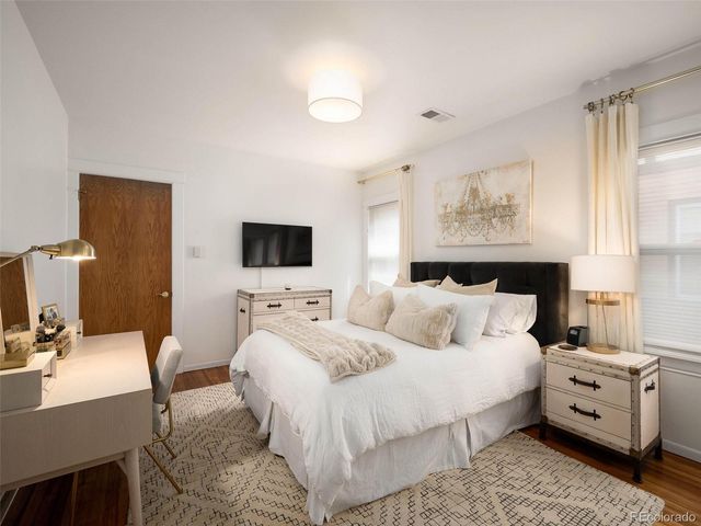 a bedroom with a bed and a flat screen tv