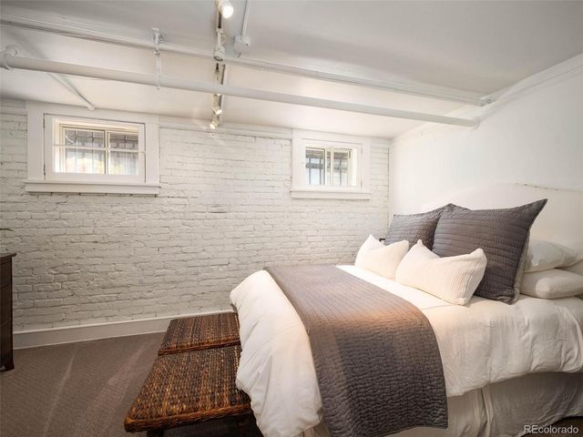 a bedroom with a bed and a night stand