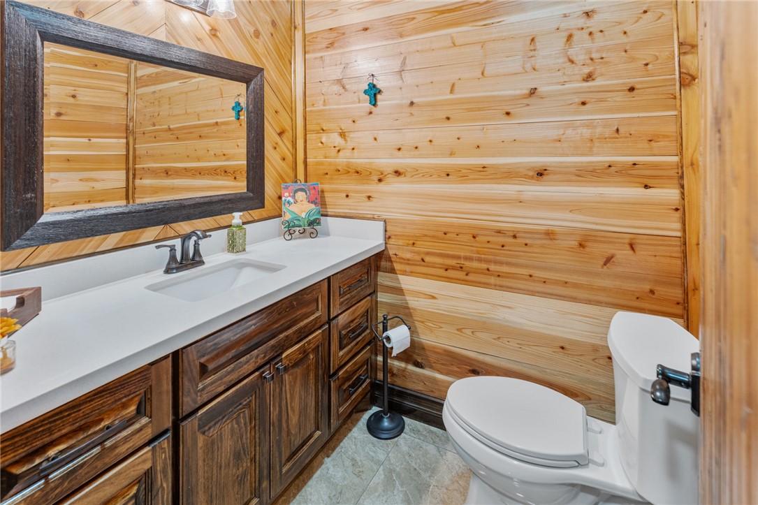 1058 South Smith Street Hebbronville, TX 78361 - Photo 15 of 40 a bathroom with a sink a toilet and a window