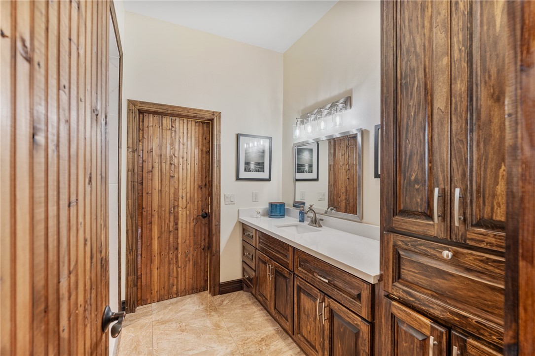 1058 South Smith Street Hebbronville, TX 78361 - Photo 18 of 40 a bathroom with a double vanity sink and a mirror