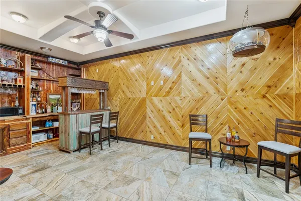 a living room with furniture a chandelier and a fireplace