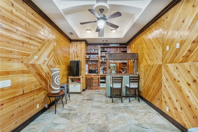 a living room with furniture a chandelier and a rug