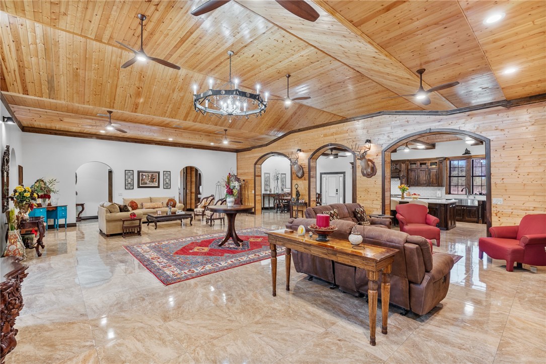 1058 South Smith Street Hebbronville, TX 78361 - Photo 27 of 40 a living room with furniture a chandelier and a fireplace