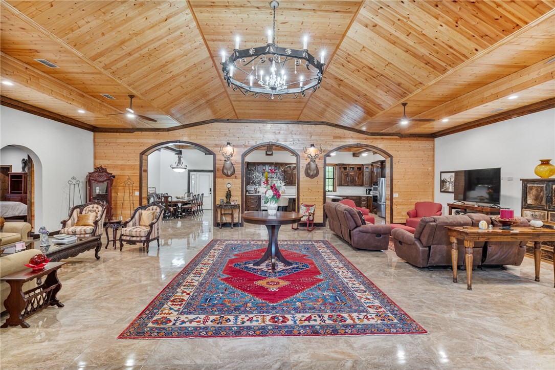 1058 South Smith Street Hebbronville, TX 78361 - Photo 28 of 40 a living room with furniture a chandelier and a rug