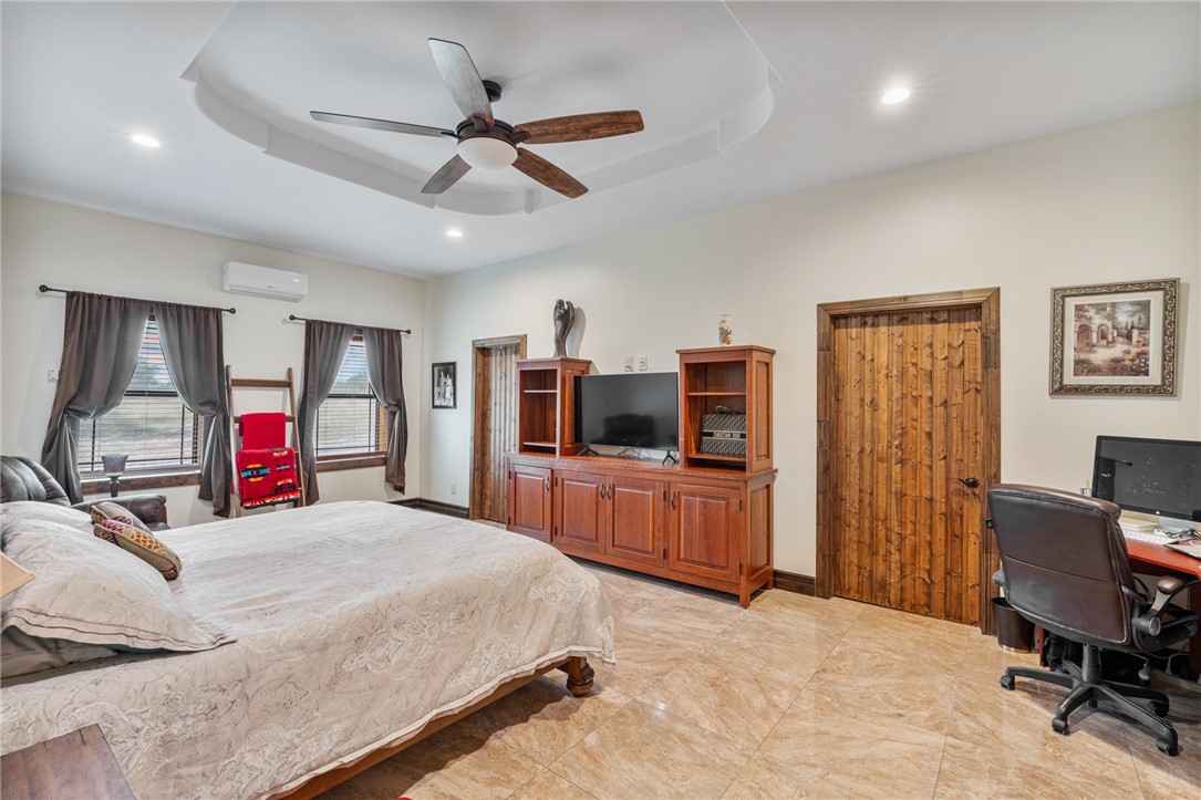 1058 South Smith Street Hebbronville, TX 78361 - Photo 34 of 40 a bedroom with a bed and a flat screen tv