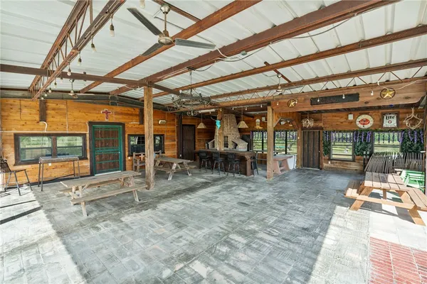 a view of a patio with dining table and chairs with wooden floor