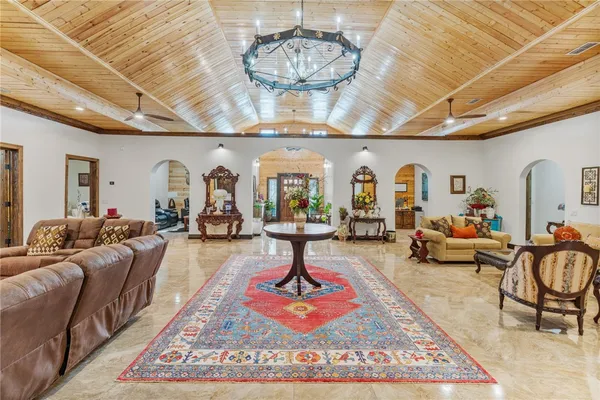 a living room with lots of furniture and a chandelier