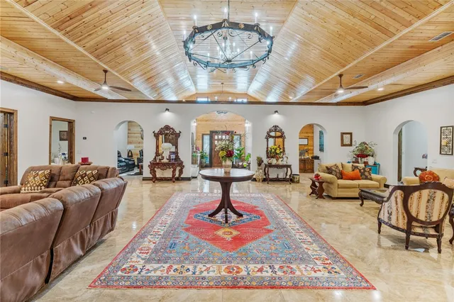 a living room with lots of furniture and a chandelier