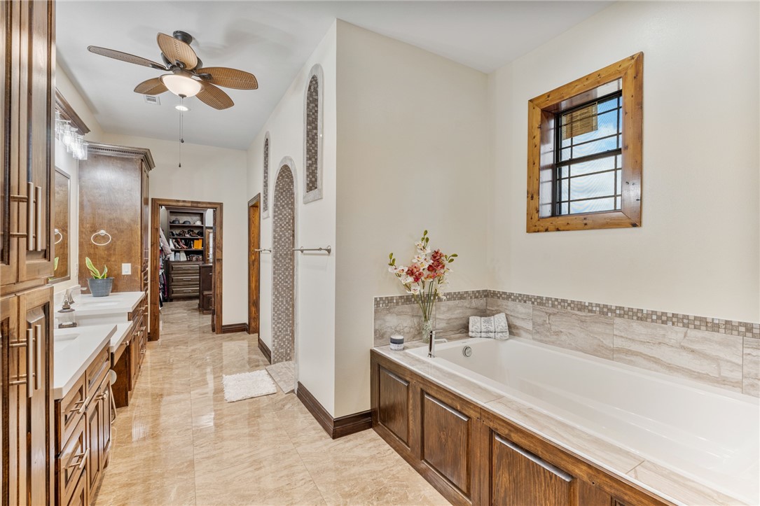 1058 South Smith Street Hebbronville, TX 78361 - Photo 10 of 40 a bathroom with a tub sink and a mirror