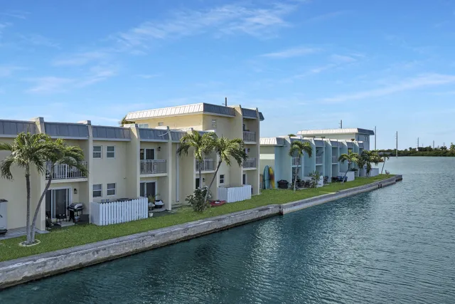 a view of a house with a yard and lake view