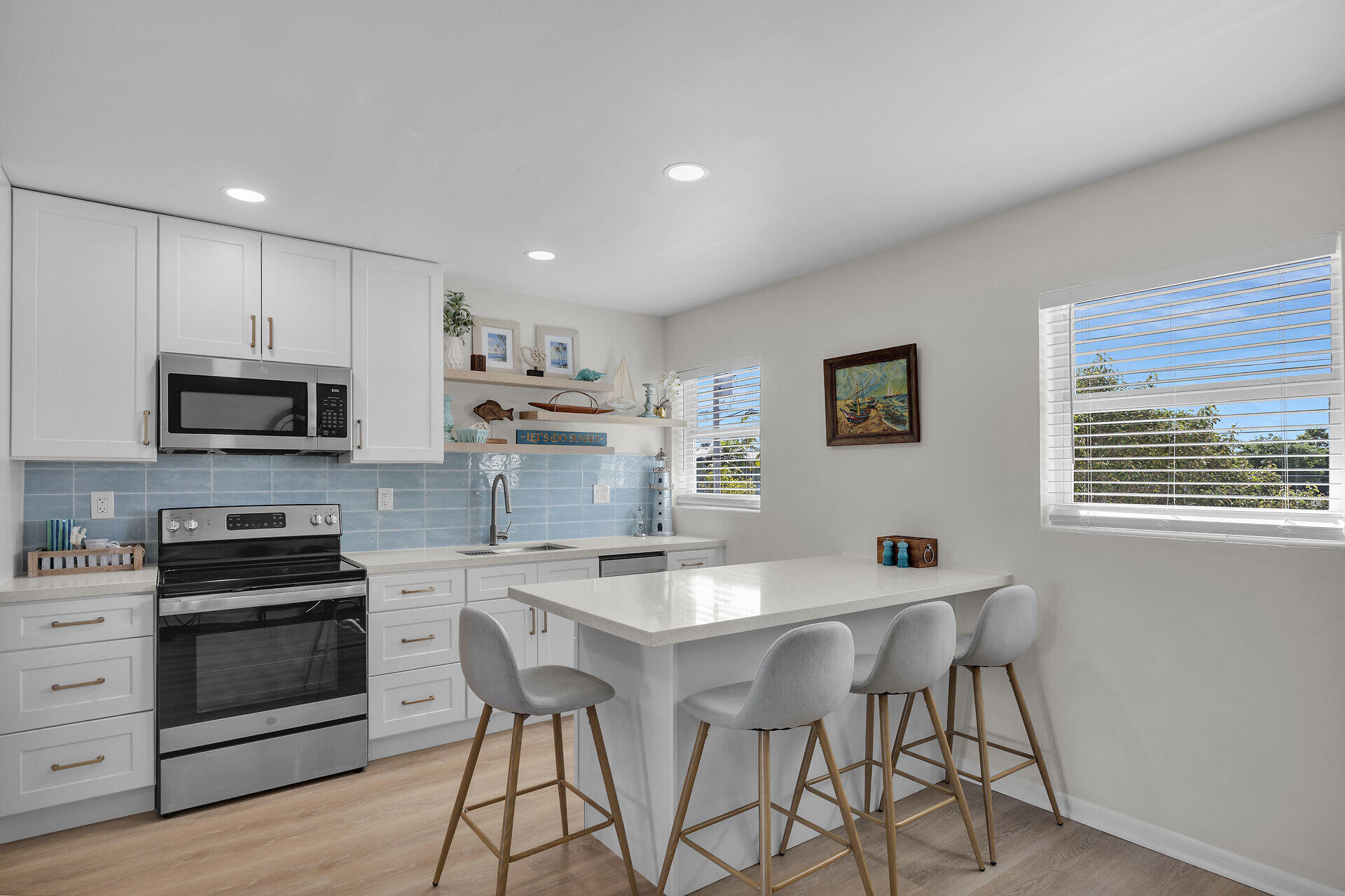 201 Coppitt Road, Unit 203B Key West, FL 33040 - Photo 17 of 44 a kitchen with stainless steel appliances kitchen island granite countertop a stove top oven a sink a counter space and cabinets