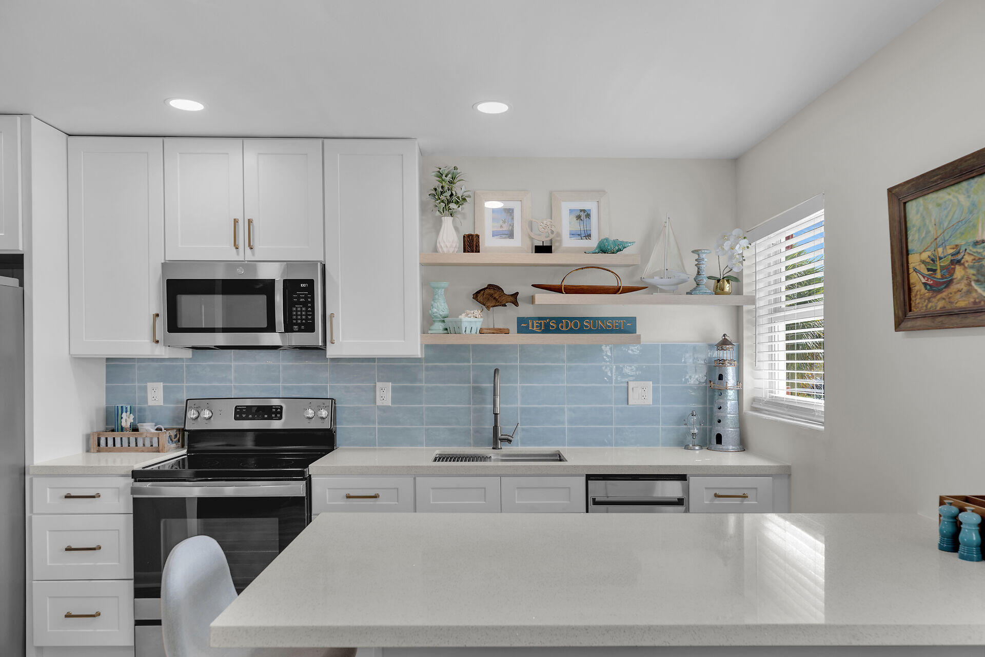 201 Coppitt Road, Unit 203B Key West, FL 33040 - Photo 18 of 44 a kitchen with stainless steel appliances kitchen island granite countertop a stove and a sink