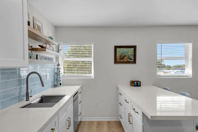 a kitchen with a sink a stove and cabinets