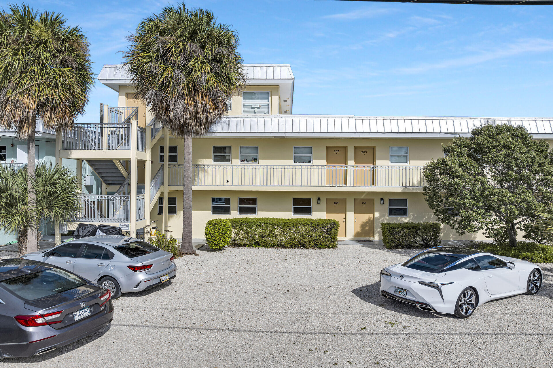 201 Coppitt Road, Unit 203B Key West, FL 33040 - Photo 2 of 44 a front view of a house with a garden