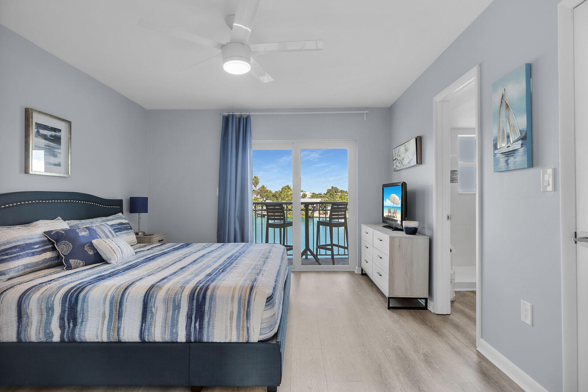 201 Coppitt Road, Unit 203B Key West, FL 33040 - Photo 26 of 44 a bedroom with a bed and a view of en suite bathroom