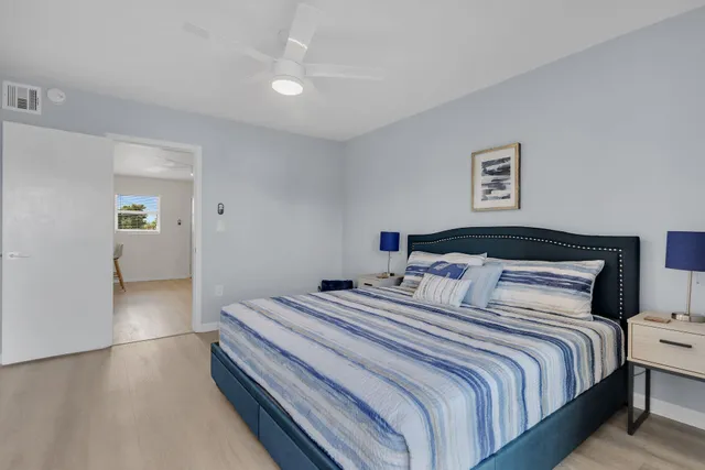 a bedroom with bed and a night stand