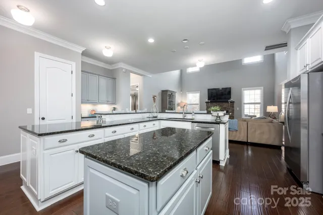 a kitchen with a center island appliances and cabinets
