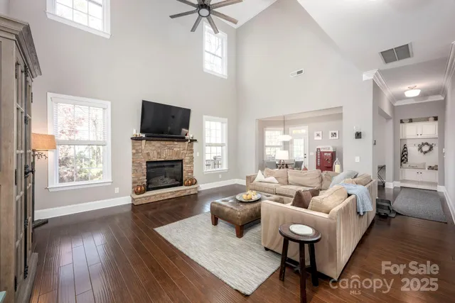 a living room with furniture a flat screen tv and a fireplace