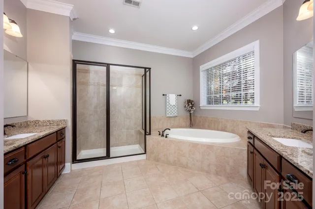 a spacious bathroom with a tub sink and mirror