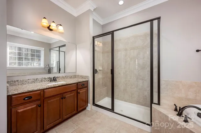 a bathroom with a granite countertop sink a mirror and a shower