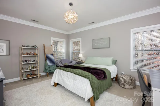 a bedroom with a bed and a chandelier