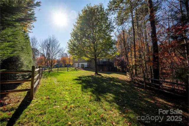 a view of yard with swimming pool and trees