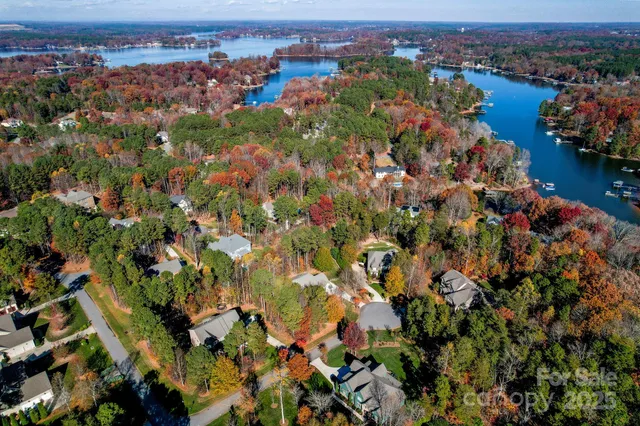 an aerial view of lake and residential houses with outdoor space