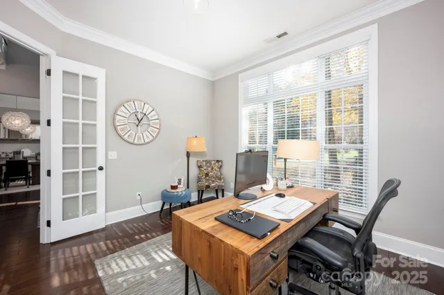 a view of a workspace with furniture and a window