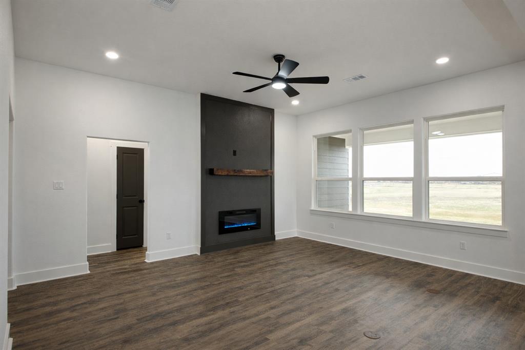 71 Arkansas Road Sadler, TX 76264 - Photo 17 of 35 a view of empty room with wooden floor and fan