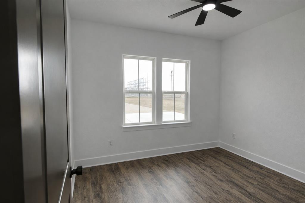 71 Arkansas Road Sadler, TX 76264 - Photo 22 of 35 an empty room with a window and a ceiling fan