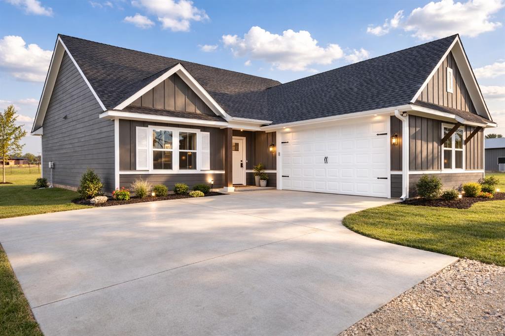 71 Arkansas Road Sadler, TX 76264 - Photo 3 of 35 a front view of a house with a yard and garage