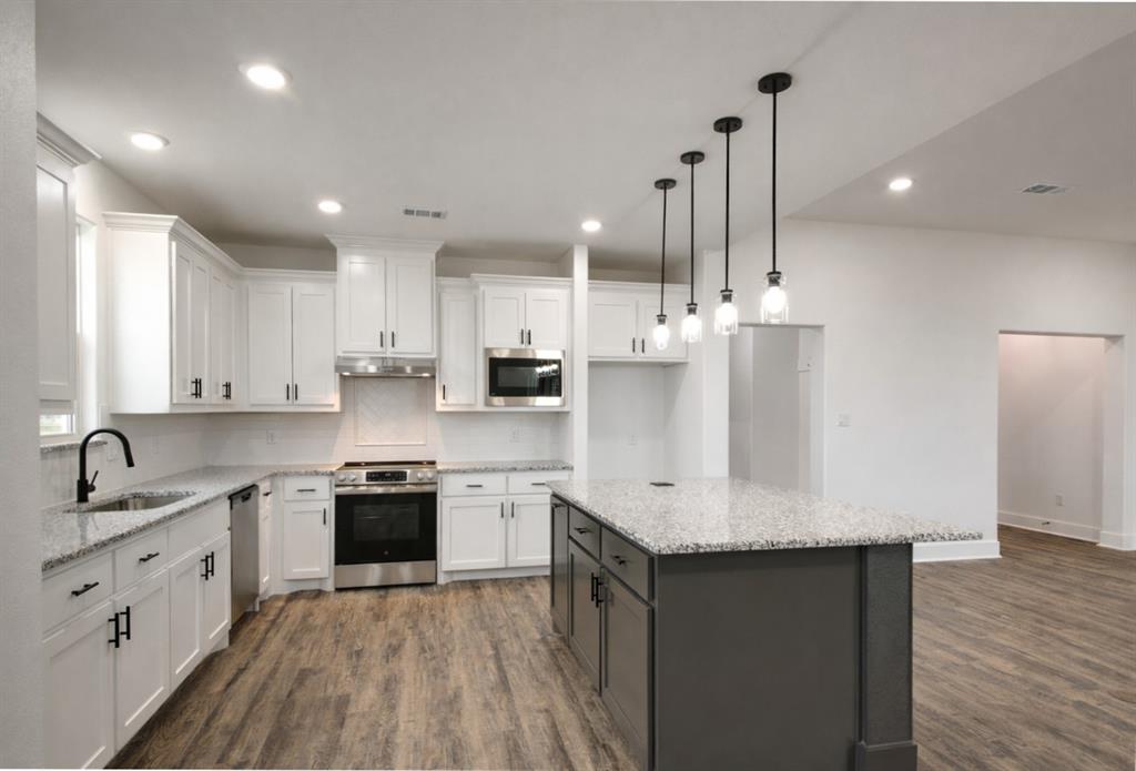 71 Arkansas Road Sadler, TX 76264 - Photo 8 of 35 a kitchen with stainless steel appliances granite countertop a sink stove and refrigerator