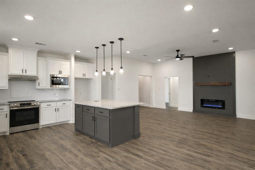 71 Arkansas Road Sadler, TX 76264 - Photo 9 of 35 a large kitchen with stainless steel appliances granite countertop a stove and a sink