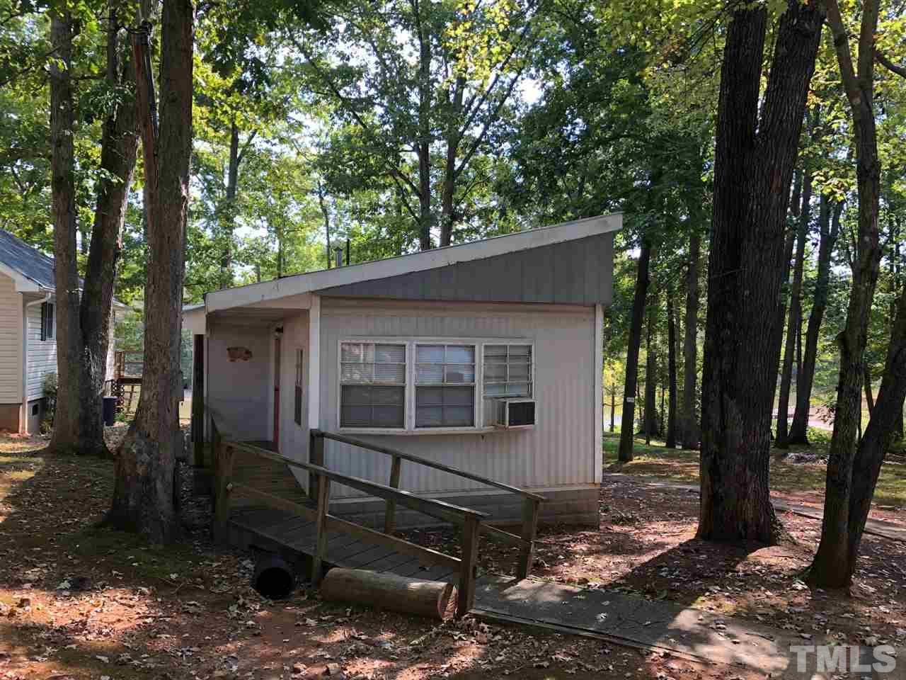 9546-9548 George Ruff Road Bullock, NC 27507 - Photo 2 of 25 a view of a house with backyard and a tree