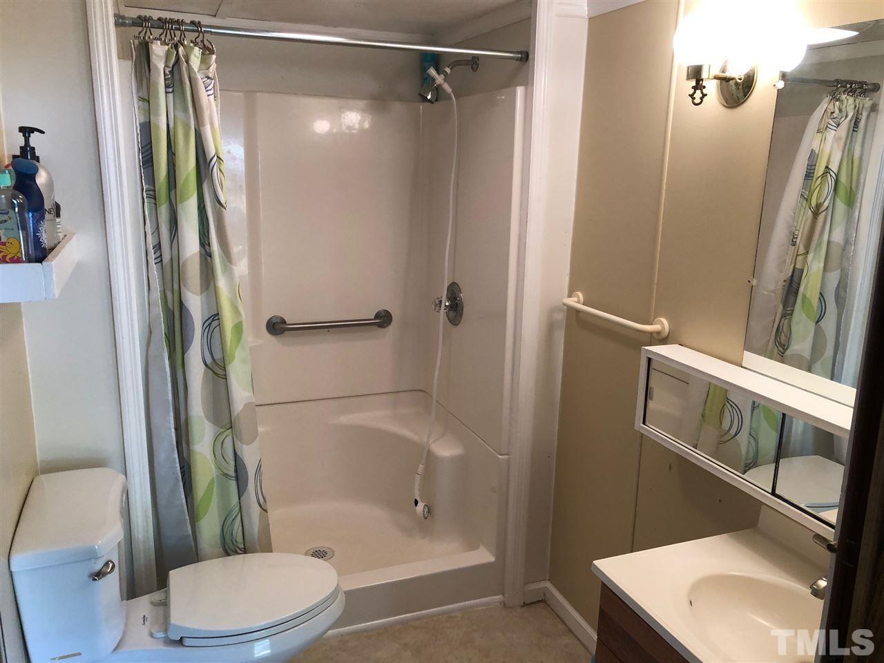 9546-9548 George Ruff Road Bullock, NC 27507 - Photo 12 of 25 a bathroom with a sink toilet and shower