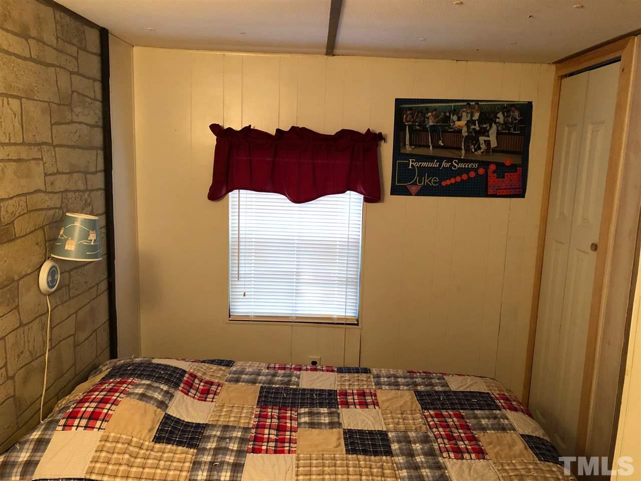 9546-9548 George Ruff Road Bullock, NC 27507 - Photo 16 of 25 a bedroom with a bed and a window