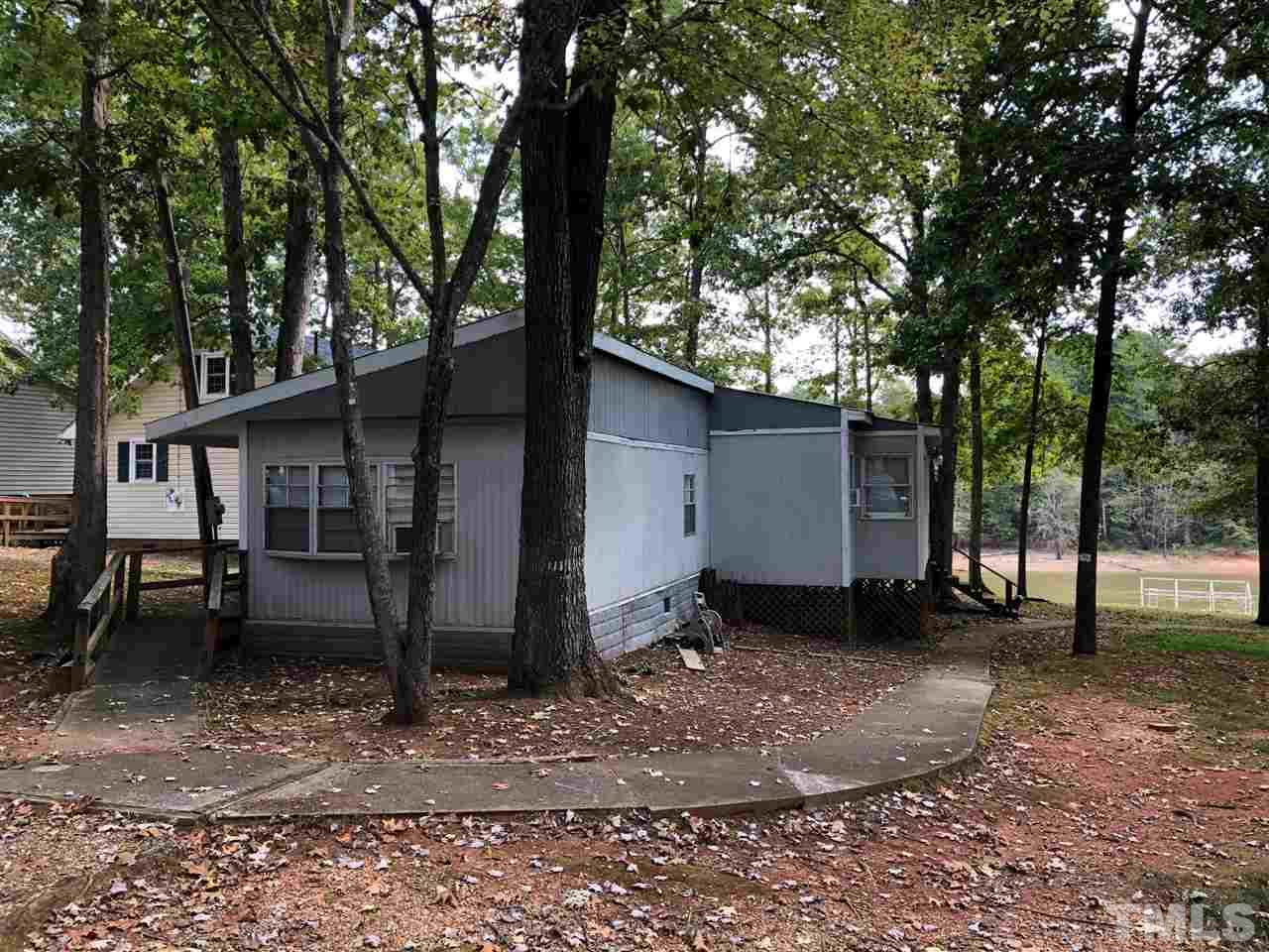9546-9548 George Ruff Road Bullock, NC 27507 - Photo 3 of 25 a view of a house with a yard