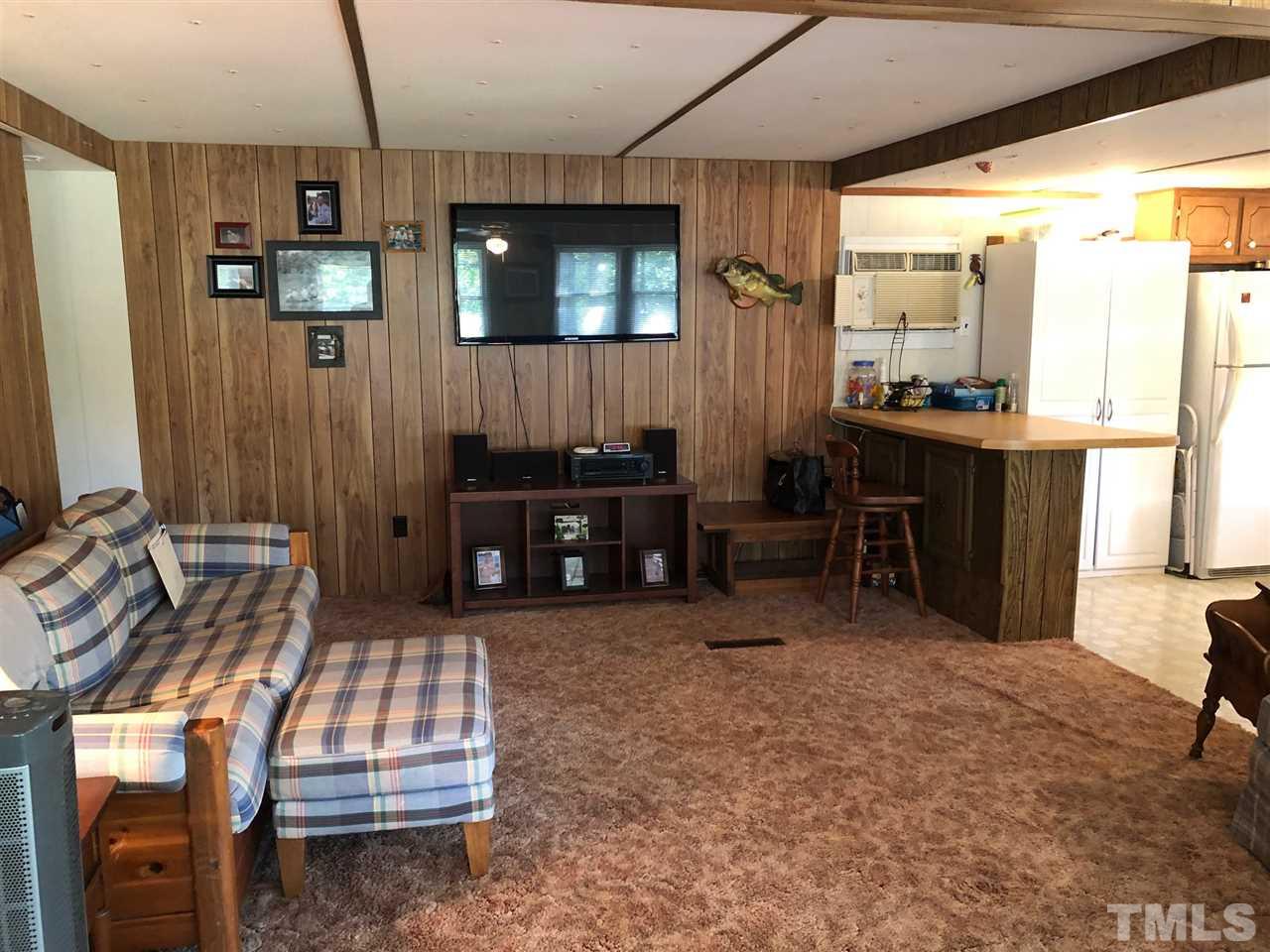 9546-9548 George Ruff Road Bullock, NC 27507 - Photo 6 of 25 a living room with furniture a window and a flat screen tv