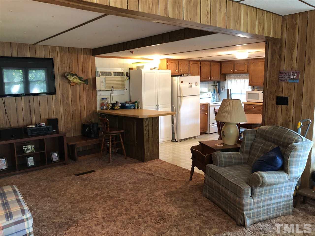 9546-9548 George Ruff Road Bullock, NC 27507 - Photo 7 of 25 a living room with furniture and a flat screen tv