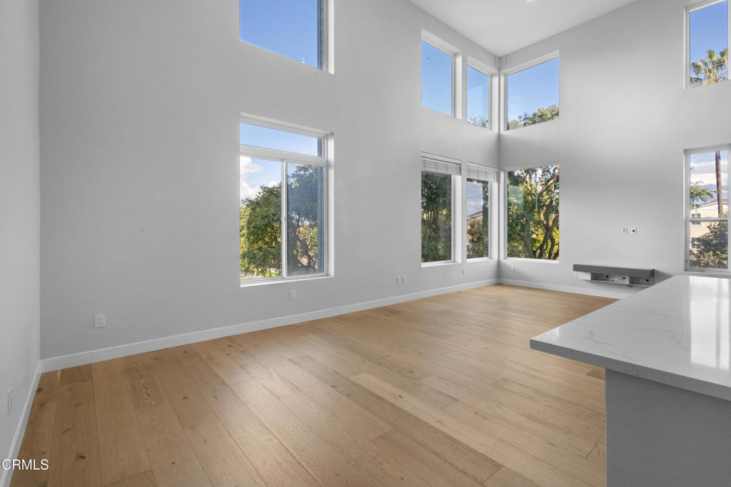 1901 South Victoria Avenue, Unit 204 Oxnard, CA 93035 - Photo 12 of 40 wooden floor in an empty room with a window