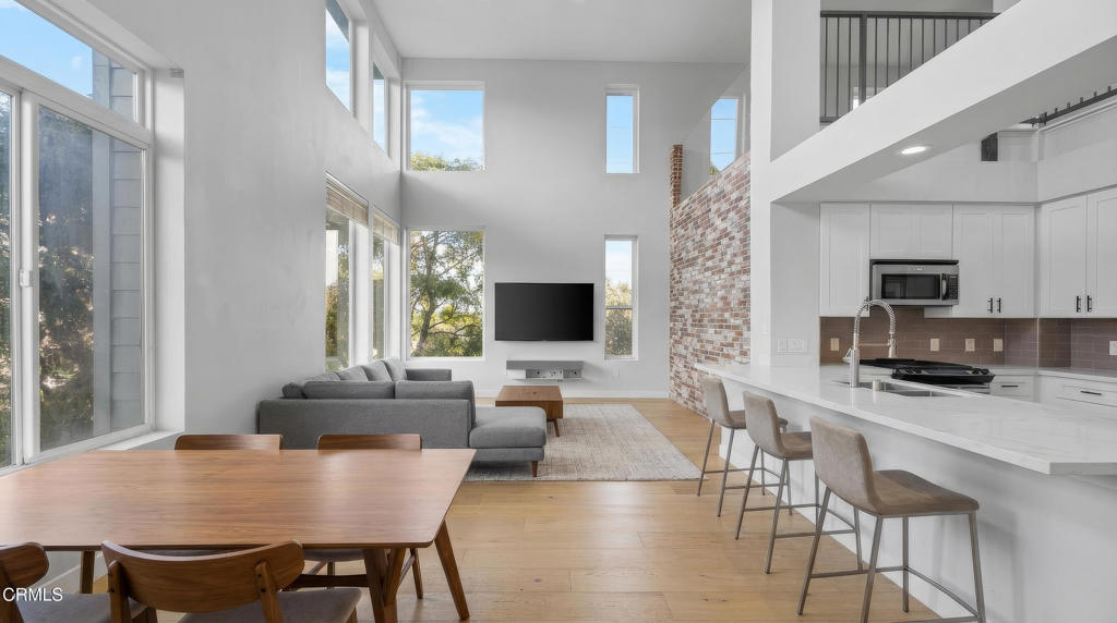 1901 South Victoria Avenue, Unit 204 Oxnard, CA 93035 - Photo 14 of 40 a living room with furniture kitchen view and a large window