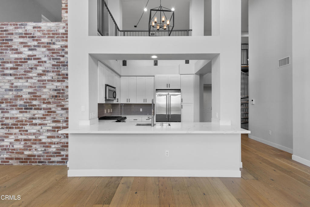 1901 South Victoria Avenue, Unit 204 Oxnard, CA 93035 - Photo 15 of 40 a large white kitchen with a sink and dishwasher