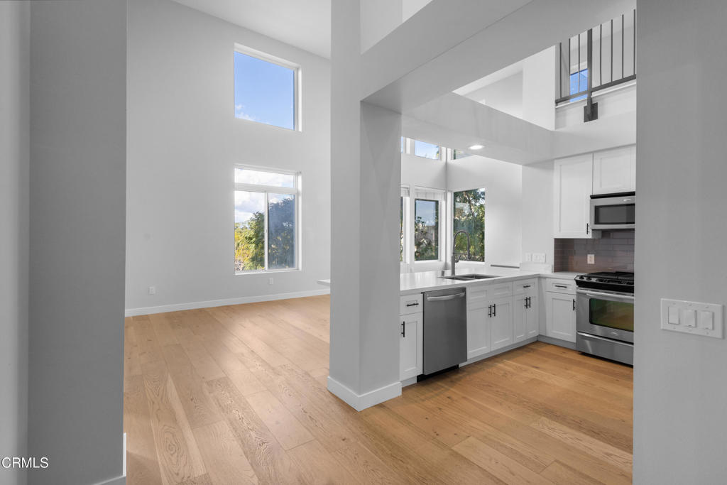 1901 South Victoria Avenue, Unit 204 Oxnard, CA 93035 - Photo 2 of 40 a kitchen with granite countertop a stove a sink and a refrigerator