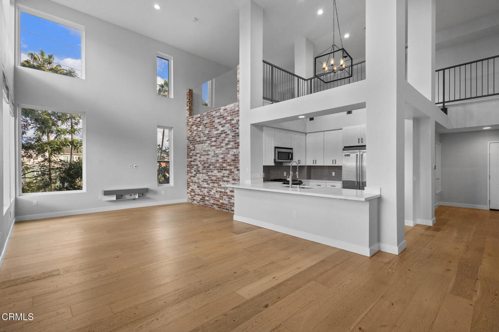 1901 South Victoria Avenue, Unit 204 Oxnard, CA 93035 - Photo 3 of 40 a kitchen with stainless steel appliances kitchen island granite countertop a refrigerator and a stove